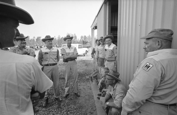 A group of International Harvester salesmen gather during a class break on the company farm at Tifton. International Harvester offered classes on the farm in order to provide its sales force with hands-on experience with agricultural equipment in the field.