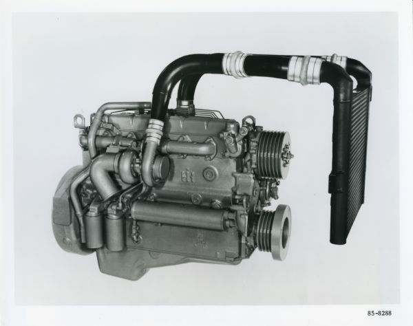 Studio photograph of an International DTA-466 in-line, six-cylinder diesel engine set against a white background.