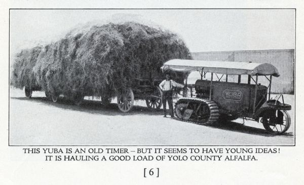 Advertisement showing a man with a Yuba tractor hauling a load of alfalfa. The caption beneath the photograph reads: "This Yuba is an old timer — but it seems to have young ideas! It is hauling a good load of Yolo County alfalfa." The tractor has an articulated track (crawler tractor).