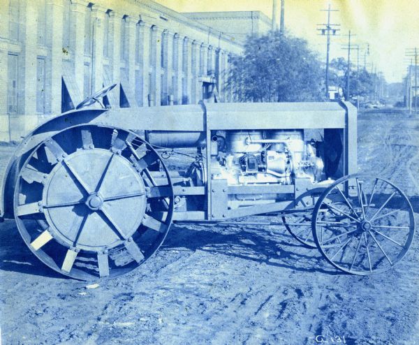 Cyanotype print of an Andrews-Kinkade Model D tractor parked in front of what appears to be a factory building.