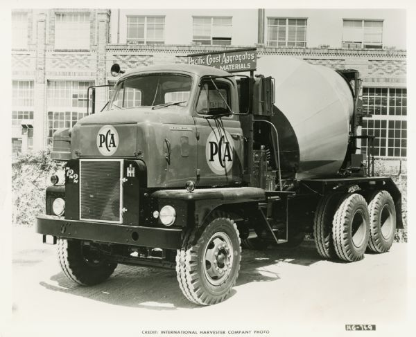 Three-quarter view from front left of an International cement mixer truck owned by San Francisco's Pacific Cement and Aggregates, Inc.