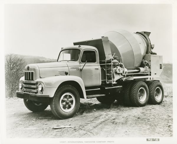 Driver's-side view of an International RF-210 truck outfitted with a concrete transit mixer body.
