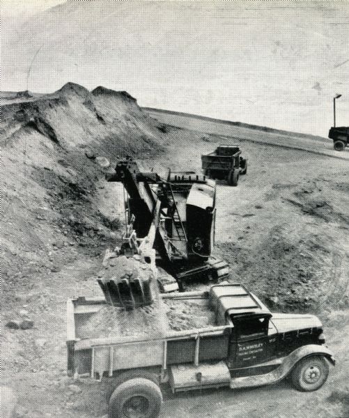 An International truck is loaded with soil on the Grand Coulee Dam construction site.