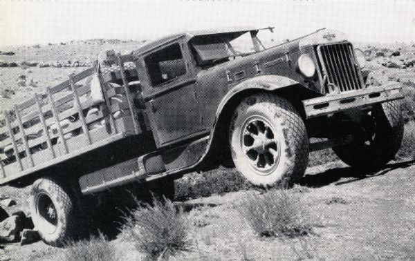 An International Model A-8 truck drives through the desert while laying the Iraq pipe line.