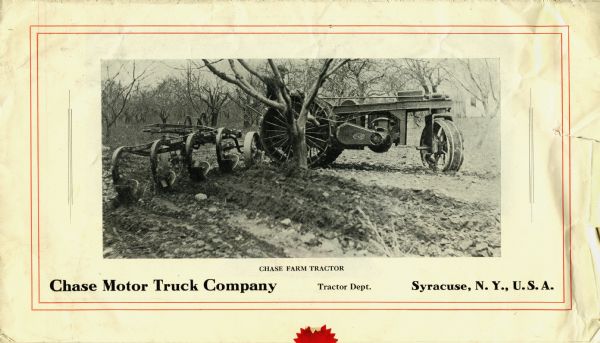 A farmer uses a Chase farm tractor and plow to work in a field dotted with trees. The Chase Motor Truck Company was based in Syracuse, New York.