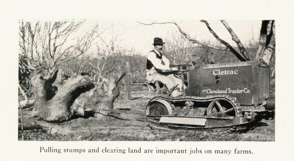 A man uses a Cletrac crawler tractor to clear land on a farm. The caption beneath the photograph reads: "Pulling stumps and clearing land are important jobs on many farms."