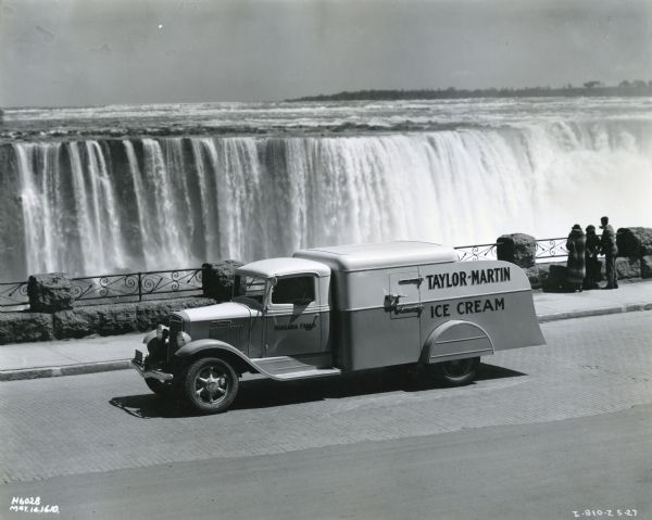Elevated view of an International C-30 truck owned by the Taylor-Martin Company parked in front of Niagara Falls.