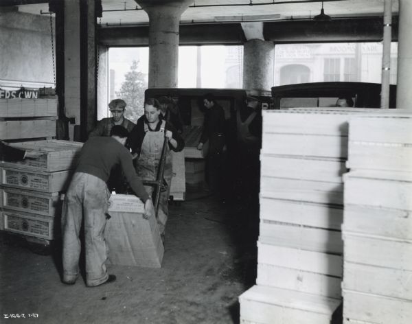 Men arrange packages in the shipping and receiving department at Washington Co-operative Egg & Poultry Association.