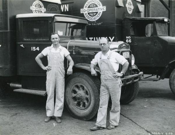 R. Brooks and A. Cleveland, drivers for Washington Egg & Poultry Co-Operative Association, pose with their two International C-line trucks.