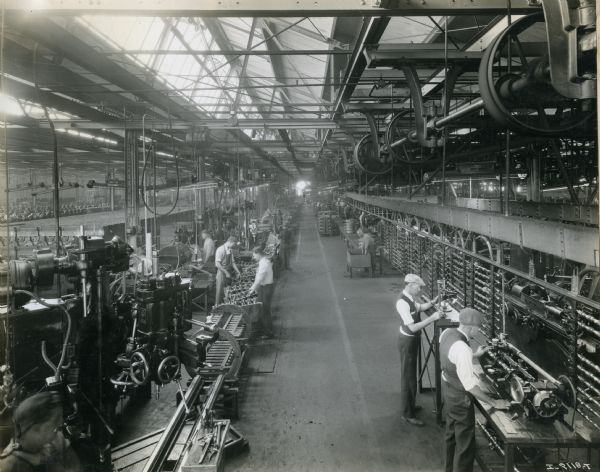 Elevated view of factory workers with machines and parts at International Harvester's Ft. Wayne Works.