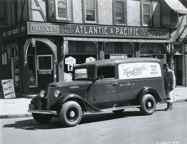 An International Model C-1 truck owned by Kaufman's Bakery parked in front of The Great Atlantic & Pacific Tea Company.