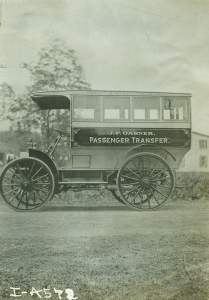 Side view of an International bus marked with the text "Lemont & State College," and "J.F. Garner, Passenger Transfer." This bus route covered a distance of approximately 7 miles between the two communities. State College is the home of The Pennsylvania State University, known until 1953 as the Pennsylvania State College.