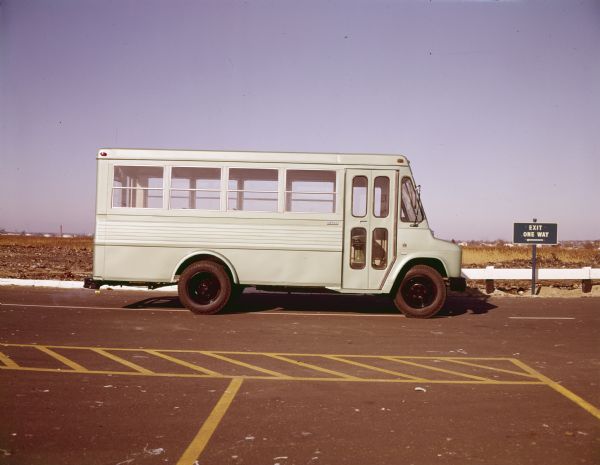 Color photograph of an International M-1500 Metro school bus parked in a parking lot.