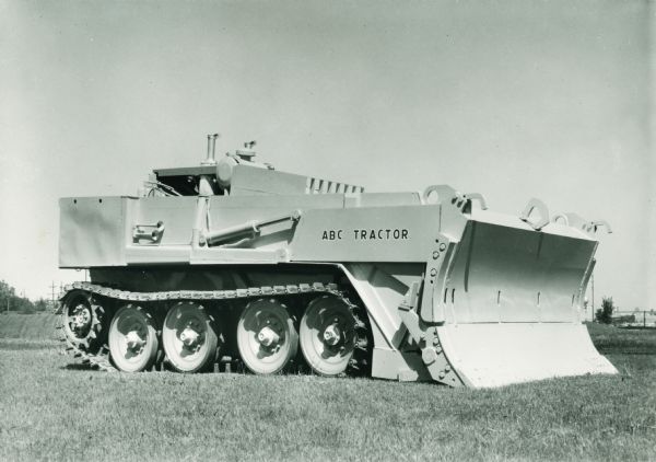 Three-quarter view from front of an ABC tractor. The original caption reads: "In April 1958, the United States Army, Corps of Engineers, awarded International Harvester Company a contract for the design, development, and fabrication of a prototype vehicle. This unit weighed 20,000 lb. empty, and 40,000 lb. loaded, with a top speed of 30 mph."