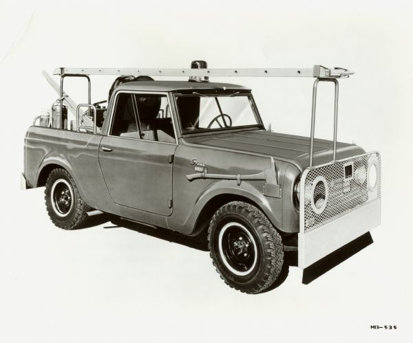 International Harvester fire-fighting Scout 80 1962. Front-left view. Original caption reads: "Photograph MQ-535-- A fire-fighting adaptation of International popular utility vehicle, the Scout is now available. the all-wheel drive model's fire-fighting apparatus includes a water tank with up to 75 gals. capacity, 8-1/4-hp. 4-cyle water pump, 100 ft. of 1-in. 2-ply 200-Ib.-test hose with an adjustable fog nozzle, 6 dry-chemical type fire extinguishers, a 12-ft. aluminum ladder, axes, shovels, brooms and buckets. Also a part of this Scout adaptation are a steel mesh grille guard, extra underside radiator protection, oversize 7.60x15 tires, revolving light, underhood siren, and hardware to hold the fire-fighting equipment in place. The 100-in.wb.Scout is powered by a 93 hp. 4-cyl. International engine. The enclosed cab seats 3 persons. MT-2342. CR-1146-D."