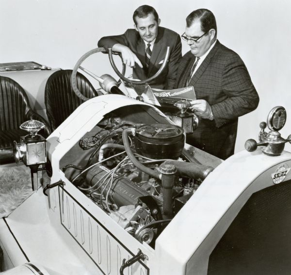 International Harvester executives discussing the 1941 Roadster. Original caption reads: "Photograph W-6074-- Stutz Bearcat replica builder and Oklahoma legislator Howard Williams (left) discusses the recreated 1914 roadster with B.J. Snodgreass, Tulsa Representative for International Harvester. IH supplies the running gear for its famous Scout vehicles. Builder Williams' authentic styling, accomplished through painstaking work from over 20 mirror-finished molds, offers the genuine feel of automotive touring with the famous Bearcat's open body. MT-3308."