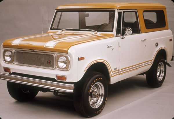 Three-quarter view from front of driver's side. White body, yellow stripes, yellow hood, yellow top. Indoor shot.