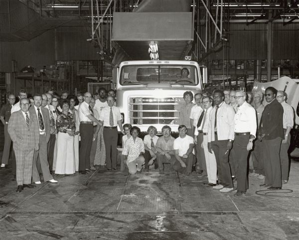 Group portrait of International Truck employees surrounding the first S Series built at the Springfield plant.