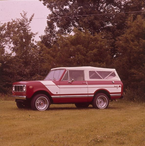 Red Scout II XLC parked outdoors. White detailing on sides, white top.