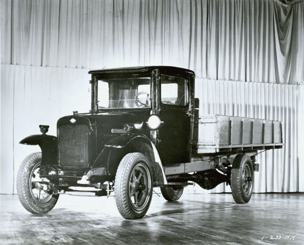 Original caption reads: "International 'speed' trucks were introduced in 1921. They offered higher speeds to match road-development progress of the 1920's. This model featured pneumatic tires, powerful six-cylinder engine and lower silhouette. Speed trucks spurred International growth as production jumped to 39,008 vehicles in 1928 from 7,183 in 1920. 4/19/62."