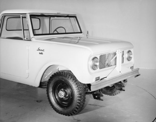 Three-quarter view from front passenger side of International Scout. On the front grille is an attachment bar, perhaps for a snow plow.