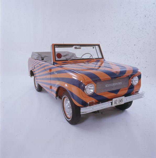 Color advertising photograph of a 1967 International Scout pickup painted in the colors of the University of Illinois.