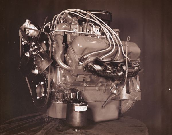 Scout engine displayed on table draped with fabric.