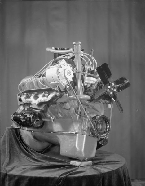 Scout engine displayed on table draped with fabric.