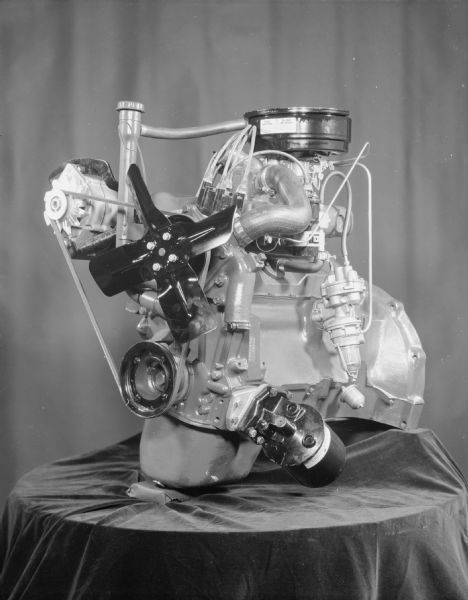 Scout engine displayed on a table draped with fabric.