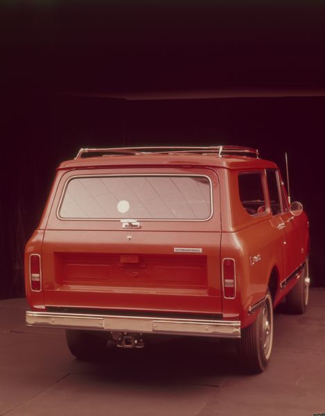 Rear view of red Scout II with red topper and roof racks.