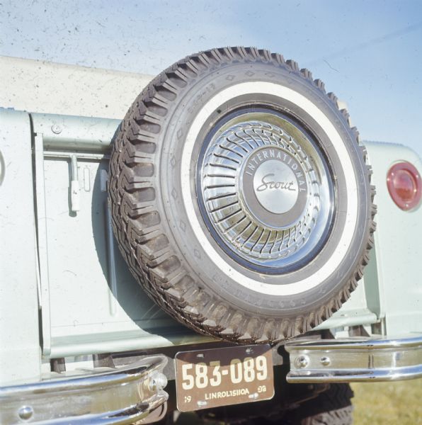 Spare tire (Goodyear) mounted on the tailgate of Scout pickup.