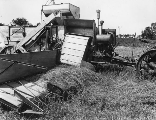 Original caption reads: "No. 20 harvester-thresher equipped with pick-up attachment. When this device is used on the No. 20 harvester-thresher the machine must be equipped with an auxiliary engine."