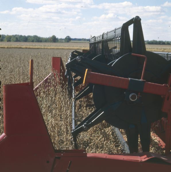 Close-up of 820 head on a combine being used in a field.