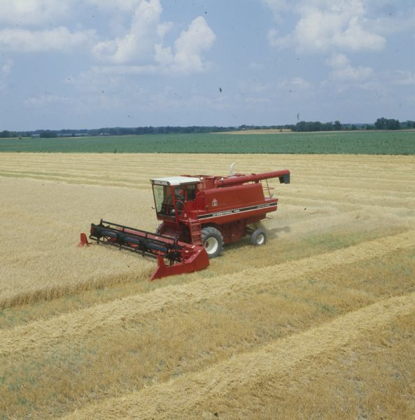 Elevated view of a man driving a 1460 combine in a field.