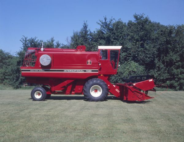 Right side view of 1420 axial-flow combine parked on a lawn.
