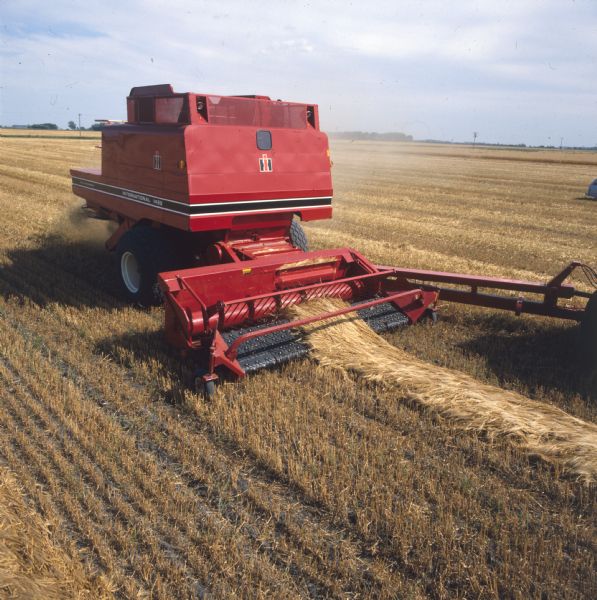 Elevated view of a pull-type 1482 axial-flow combine in a field. Part of the tractor is on the right.