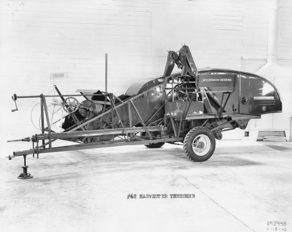 Side view interior studio shot of a McCormick-Deering No. 62 pull type Harvester Thresher.