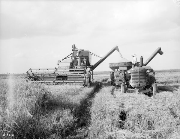 Men Using Combine In Field 