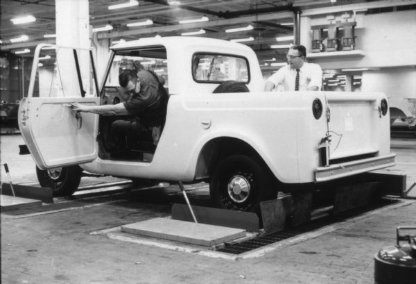Two Fort Wayne employees testing out a fully built Scout on the plant floor. Assembly line image from International Harvester's Fort Wayne plant, subject of a 1961 article in <i>International Harvester Today</i> entitled: "The Scout."