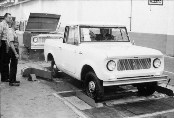Several IH employees of the Fort Wayne plant moving Scout's down the assembly line along rollers. A driver behind the wheel indicates that this particular Scout was nearing completion. Assembly line image from International Harvester's Fort Wayne plant, subject of a 1961 article in <i>International Harvester Today</i> entitled: "The Scout."