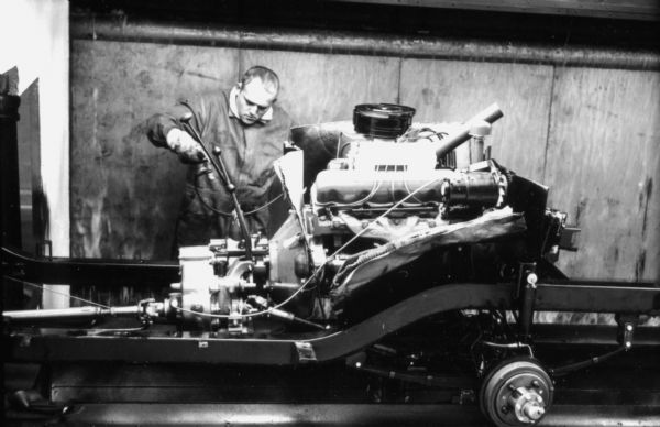 Fort Wayne employee adjusting the transmission of an International Scout. Assembly line image from International Harvester's Fort Wayne plant, subject of a 1961 article in <i>International Harvester Today</i> entitled: "The Scout."