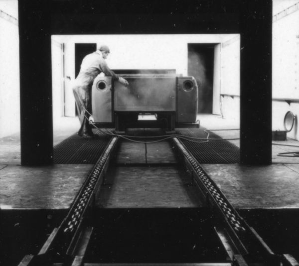 Fort Wayne employee touching up a Scout body in the International paint booth. Assembly line image from International Harvester's Fort Wayne plant, subject of a 1961 article in <i>International Harvester Today</i> entitled: "The Scout."
