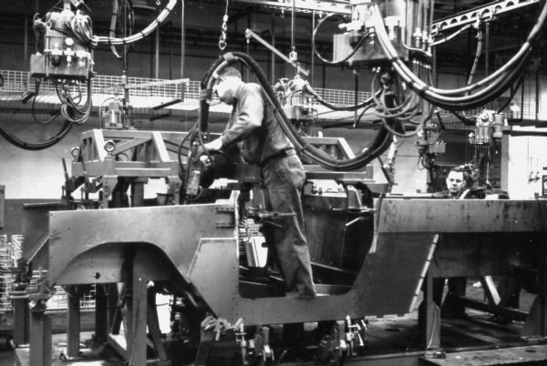 Fort Wayne employees assembling the body of an International Scout. Assembly line image from International Harvester's Fort Wayne plant, subject of a 1961 article in <i>International Harvester Today</i> entitled: "The Scout."