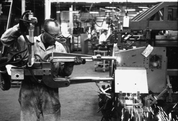 Fort Wayne employee using a power tool to assemble the body of an International Scout. Assembly line image from International Harvester's Fort Wayne plant, subject of a 1961 article in <i>International Harvester Today</i> entitled: "The Scout."