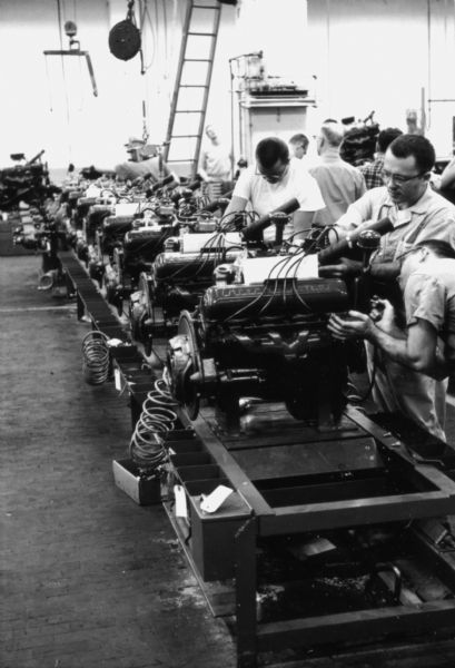 View down a row of International V-8 engines as men prepare them for assembly. Assembly line image from International Harvester's Fort Wayne plant, subject of a 1961 article in <i>International Harvester Today</i> entitled: "The Scout."
