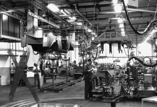Elevated International Scout body lifted into the air as it continues on the assembly line. Assembly line image from International Harvester's Fort Wayne plant, subject of a 1961 article in <i>International Harvester Today</i> entitled: "The Scout."