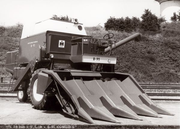 Outdoor view of a combine 8-91 parked near railroad tracks.