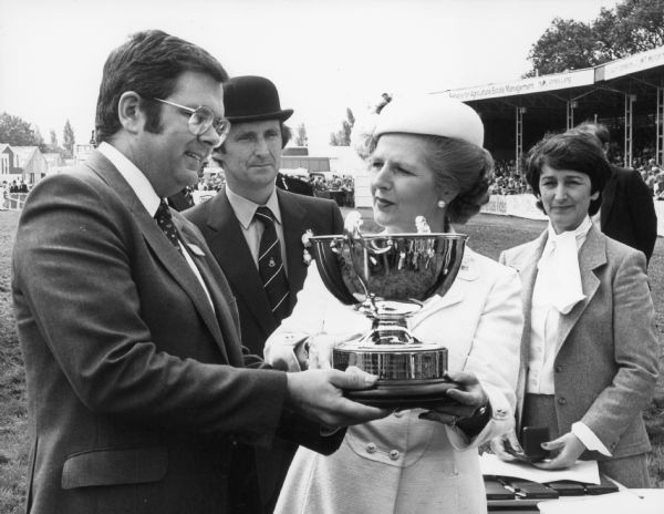 Prime Minister Mrs. Margaret Thatcher, M.P., presents the Burke Trophy to Bud Thompson, Managing Director of IHBG, at the Royal Show, in Warwickshire, England.