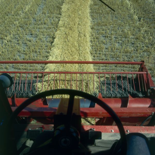 View from driver's seat of a 1480 Axial Flow Combine in a field.