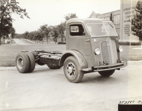 Three-quarter view from front of right side of Model C-70 cab over parked in front of Fort Wayne factory. Note front opening doors.
